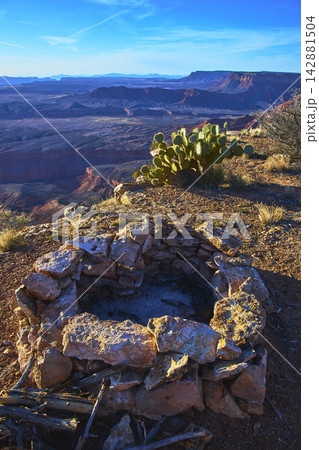 Stone Fire Ring Cactus and Expansive Desert Canyon Landscape at Sunset Stone Fire Ring Cactus and Expansive Desert Canyon Landscape at Sunset 142881504