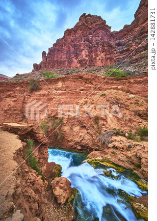 Hidden Falls Turquoise Waterfall and Red Canyon Cliffs in Havasupai Arizona Hidden Falls Turquoise Waterfall and Red Canyon Cliffs in Havasupai Arizona 142881731