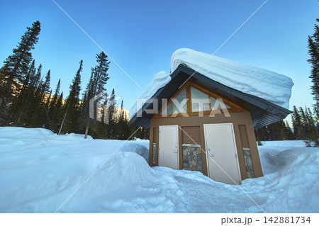 Winter Restroom Building with Deep Snow and Pine Forest in Canada Winter Restroom Building with Deep Snow and Pine Forest in Canada 142881734