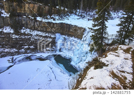 Frozen Waterfall and Snowy Cliffs at Crescent Falls in Winter Forest Landscape 142881755