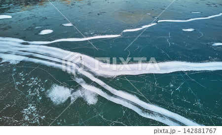 Aerial Frozen Abraham Lake Ice Patterns With Hiker in Alberta Winter Aerial Frozen Abraham Lake Ice Patterns With Hiker in Alberta Winter 142881767