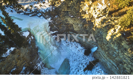 Aerial Frozen Waterfall and Rocky Cliff Isaacs Ice Fall in Alberta Winter 142881821