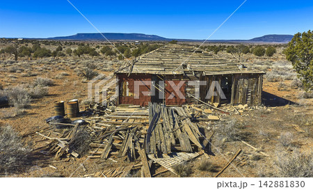 Abandoned Desert Cabin Ruins with Distant Plateau and Mount Trumbull Arizona 142881830