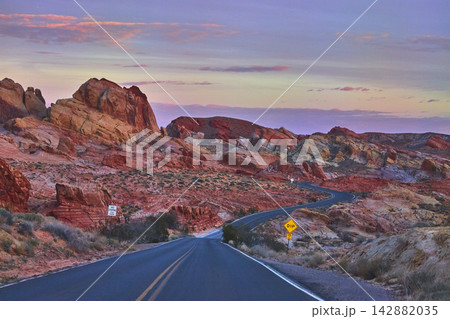 Winding Road and Colorful Rock Formations at Sunrise in Valley of Fire Nevada Winding Road and Colorful Rock Formations at Sunrise in Valley of Fire Nevada 142882035