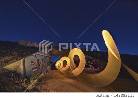 Light Painting Under Graffiti Bridge at Night in Nevada Desert Blue Hour Light Painting Under Graffiti Bridge at Night in Nevada Desert Blue Hour 142882113
