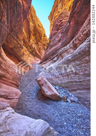 Slot Canyon Rock Formations and Sunlit Path in Vibrant Desert Landscape Slot Canyon Rock Formations and Sunlit Path in Vibrant Desert Landscape 142882244