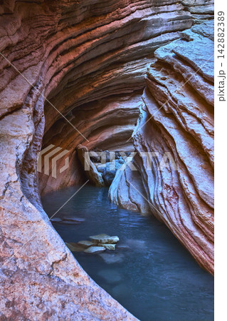 Slot Canyon Water Pools and Layered Rock Formations in Colorful Desert Light Slot Canyon Water Pools and Layered Rock Formations in Colorful Desert Light 142882389