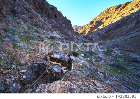 Abandoned Rusted Car in Desert Canyon with Graffiti and Rocky Mountains Nevada Abandoned Rusted Car in Desert Canyon with Graffiti and Rocky Mountains Nevada 142882393