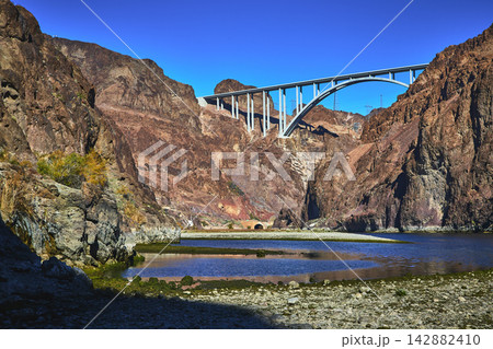 Colorado River Bridge and Rocky Canyon Walls with Water in Nevada Colorado River Bridge and Rocky Canyon Walls with Water in Nevada 142882410