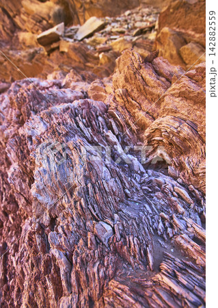 Layered Red Rock Texture and Sunlit Slot Canyon Formations 142882559