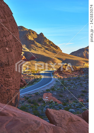 Winding Road and Redstone Dunes at Sunrise in Nevada Desert Landscape Winding Road and Redstone Dunes at Sunrise in Nevada Desert Landscape 142883074