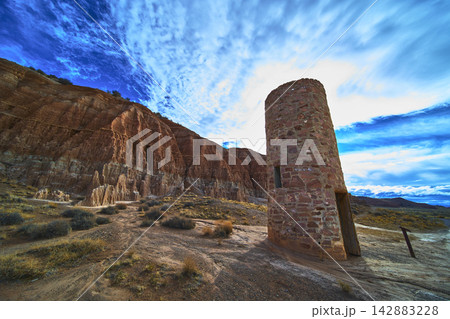 CCC Water Tower and Cathedral Gorge Cliffs Under Dramatic Nevada Sky 142883228