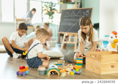 Childrens leisure, supervised children, children playing in living room of kindergarten. Childrens leisure, supervised children, children playing in living room of kindergarten. 142884039
