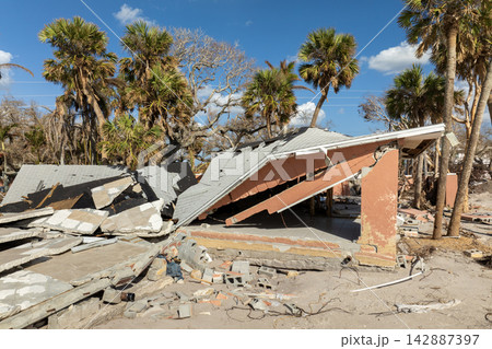 Ruined buildings in need of demolition or repair. Storm surge water and wind damaged houses roof and collapsed walls after hurricane in Florida Ruined buildings in need of demolition or repair. Storm surge water and wind damaged houses roof and collapsed walls after hurricane in Florida 142887397
