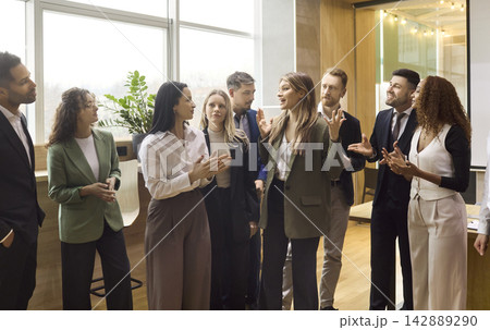 Diverse business team applauding leader during office meeting and presentation Diverse business team applauding leader during office meeting and presentation 142889290