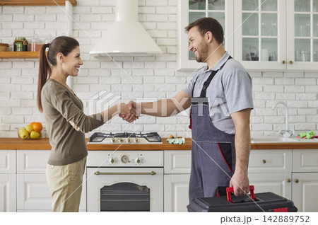 Workman Shaking Hands With Client In Kitchen 142889752