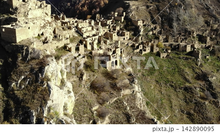 Overgrown Abandoned Mountain Settlement. Weathered Stone Structures On Hillside Gradually Reclaiming Space. Media Overgrown Abandoned Mountain Settlement. Weathered Stone Structures On Hillside Gradually Reclaiming Space. Media 142890095