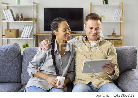 Happy using digital tablet at home, online browsing and planning together 142890818