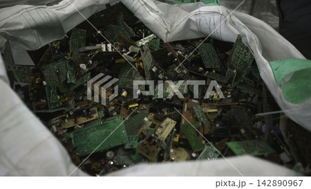 Multiple Personnel Work In Unison To Disassemble And Sort Circuit Boards Efficiently At Recycling Facility . Media 142890967