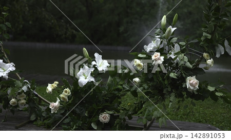 Beautiful Blossoms And Greenery Create Intimate Romantic Decor By Lakeside Under Cloudy Sky . Media Beautiful Blossoms And Greenery Create Intimate Romantic Decor By Lakeside Under Cloudy Sky . Media 142891053