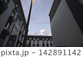 Glowing streetlight above modern apartment courtyard 142891142