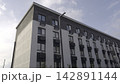 High Angle Shot Of Residential Facade. Tall Lamppost Beside Modern Brick Apartment With Blue Sky. Stock Clip 142891144