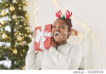 Portrait Of An African American Woman Celebrating New Year Or Christmas Portrait Of An African American Woman Celebrating New Year Or Christmas 142894540