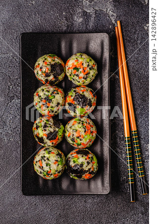 Korean rice balls (jumeokbap) with vegetables served with sauce Korean rice balls (jumeokbap) with vegetables served with sauce 142896427