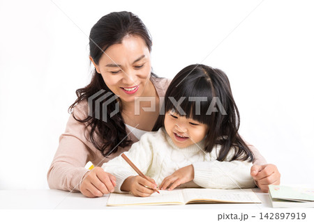Asian Mother and Daughter Laughing Together While Studying 142897919