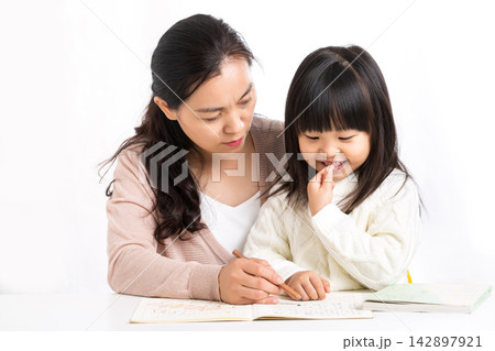 Asian Mother and Daughter Laughing Together While Studying Asian Mother and Daughter Laughing Together While Studying 142897921