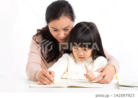 Asian Mother and Daughter Laughing Together While Studying Asian Mother and Daughter Laughing Together While Studying 142897923