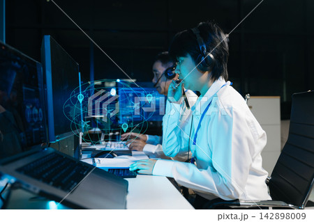 Female air traffic controller operates keyboard and monitors radar screen Female air traffic controller operates keyboard and monitors radar screen 142898009