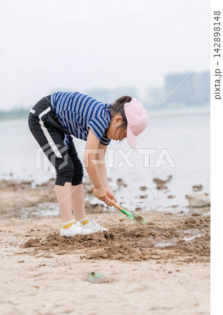 Children Playing with Sand and Water Tools on the Beach, Kids Exploring Muddy Shoreline, Sensory Play and Nature Discovery 142898148