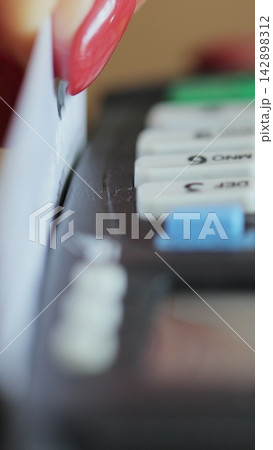 Vertical video. Credit card machine for money transaction. Close up of woman hand with credit card swipe through pos terminal and enter pin code. Banking services of electronic money. Financial 142898312