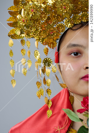Traditional Gold Headdress Portrait Of A Indonesian Asian Woman In Ornate Ceremonial Costume With Red Silk And Rose 142899990