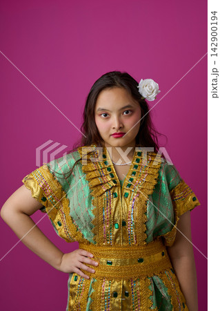 Portrait of Young Indonesian Asian Woman in Ornate Traditional Green and Gold Dress With White Flower Portrait of Young Indonesian Asian Woman in Ornate Traditional Green and Gold Dress With White Flower 142900194