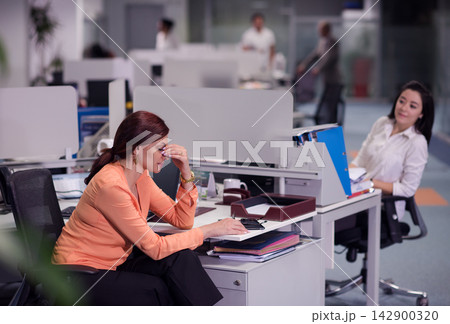 Middle Eastern businesswoman looking stressed in modern open-plan office during a corporate meeting at a startup 142900320