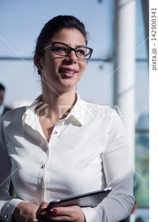 Middle Eastern businesswoman smiling in modern open space startup office during a casual business meeting Middle Eastern businesswoman smiling in modern open space startup office during a casual business meeting 142900341