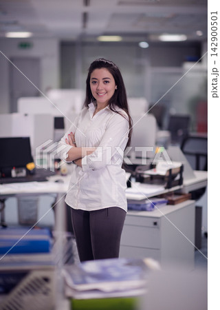 Middle Eastern businesswoman smiling in modern open office environment at a startup corporate workplace 142900501