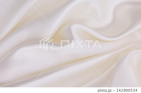 Smooth elegant white silk or satin luxury cloth texture as wedding background. Luxurious background design Smooth elegant white silk or satin luxury cloth texture as wedding background. Luxurious background design 142900534
