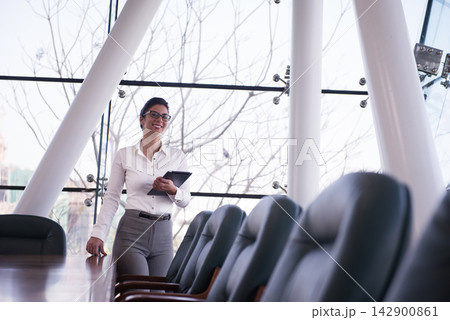 Middle Eastern businesswoman leading a meeting in a modern startup corporate office with confident smile 142900861