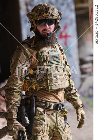 Tactical Soldier In Multicam Gear With Helmet, Plate Carrier And Radio In Urban Environment 142901312