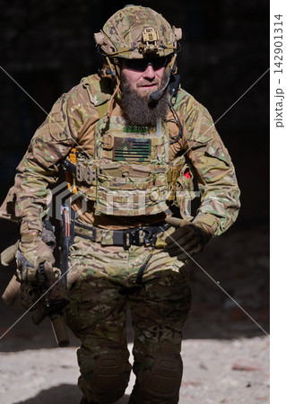 Bearded Special Forces Soldier in Tactical Camouflage Gear Running With Rifle and Helmeted Helmet Mounted Headset Bearded Special Forces Soldier in Tactical Camouflage Gear Running With Rifle and Helmeted Helmet Mounted Headset 142901314
