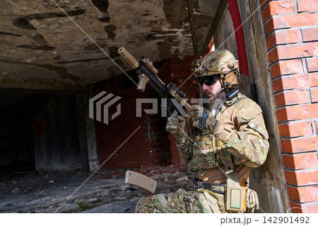 Tactical Soldier In Camouflage With Rifle During Urban Combat Training In Abandoned Building Tactical Soldier In Camouflage With Rifle During Urban Combat Training In Abandoned Building 142901492