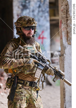 Tactical Soldier in Camouflage Gear Holding Rifle During Urban Military Training Operation 142901496