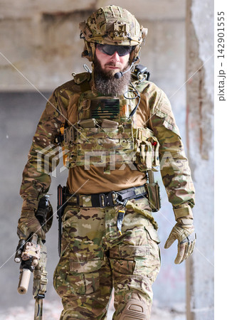 Armed Soldier In Tactical Gear Walking Through Urban Ruins During Military Operation Training Armed Soldier In Tactical Gear Walking Through Urban Ruins During Military Operation Training 142901555