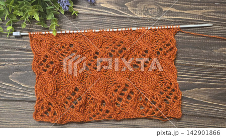 Multicolored hand-knitted fabric. Knitting and crochet lessons. Fashion Multicolored hand-knitted fabric. Knitting and crochet lessons. Fashion 142901866
