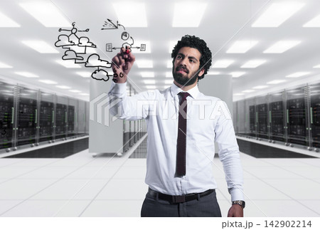 Middle Eastern businessman drawing cloud network diagram in modern data center during corporate meeting 142902214
