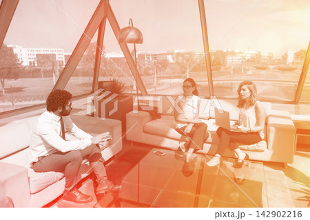 Middle Eastern business people having a casual corporate meeting in a modern open office lounge space 142902216