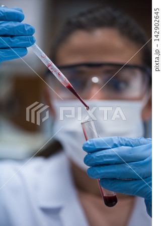 Middle Eastern lab technician and young doctor performing blood test with pipette and test tube 142902645